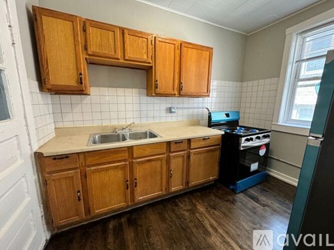 A kitchen with wooden cabinets and a white sink.