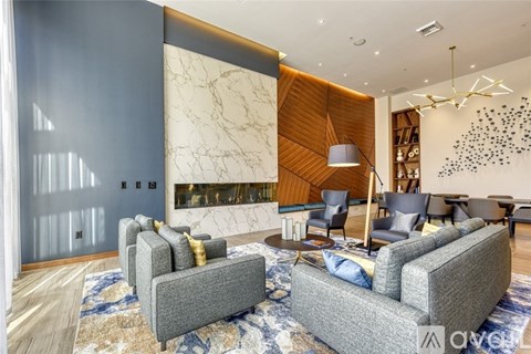 A living room with grey couches and a wooden wall.
