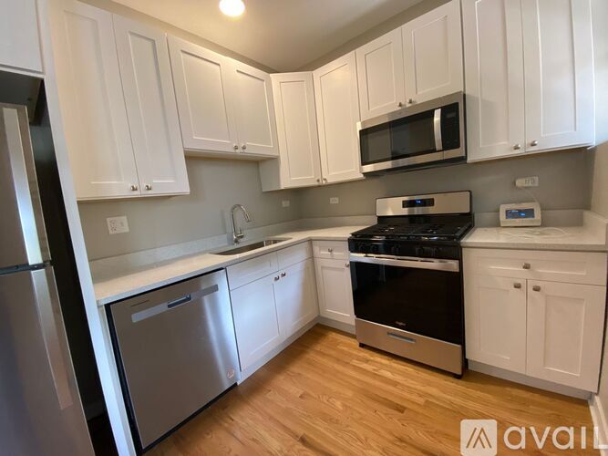 A kitchen with white cabinets and stainless steel appliances.