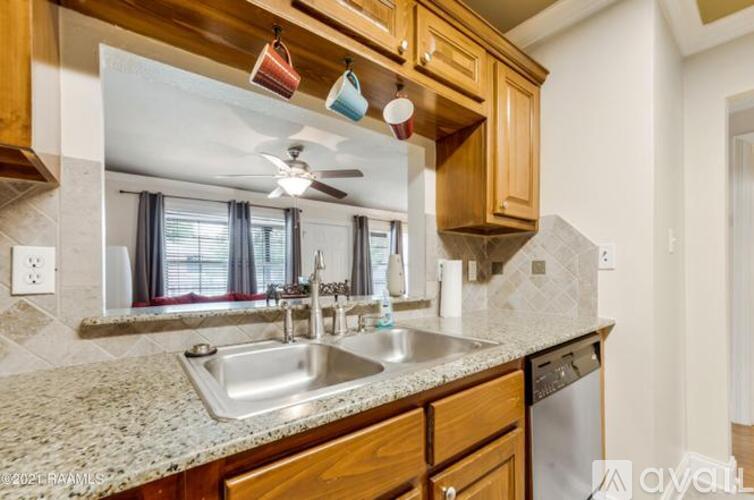 A kitchen with wooden cabinets and granite countertops.
