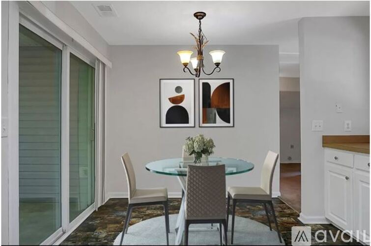 A dining room with a glass table and chairs.