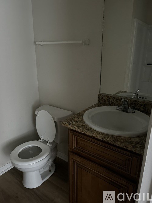 A white toilet sits next to a sink in a bathroom.