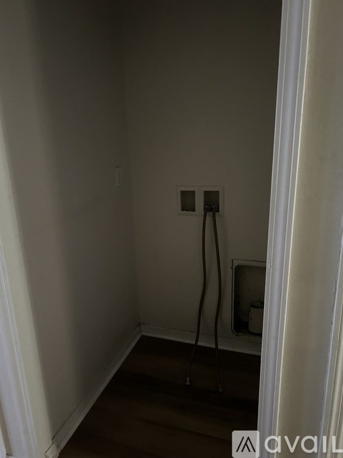A white wall with a socket and a cable running across it.