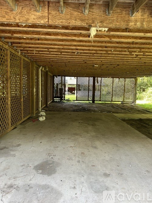 A large, unfinished room with a wooden ceiling and walls.
