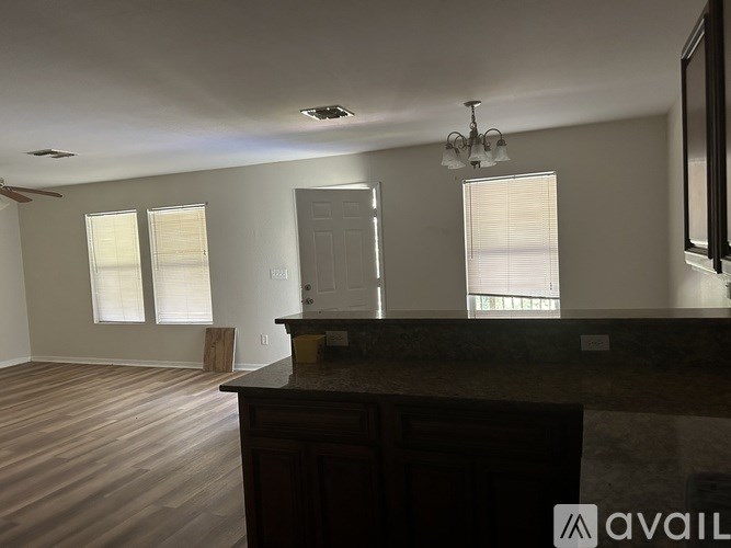 A room with a brown countertop and a ceiling fan.