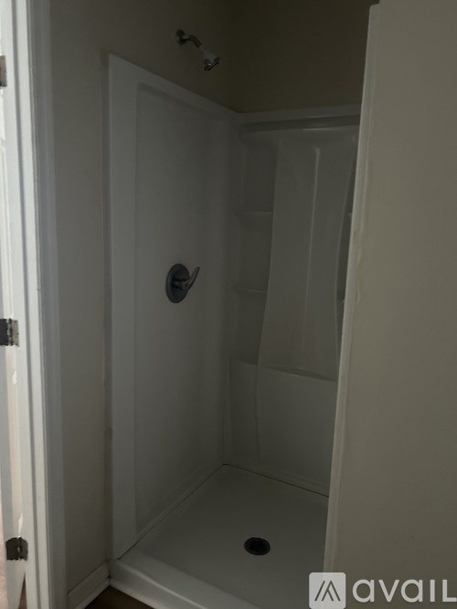 A white bathroom with a shower stall.