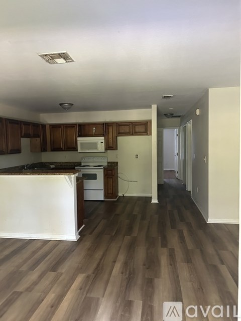 A kitchen with wooden cabinets and a white island.