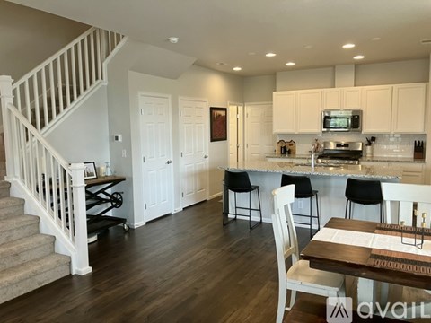 A kitchen with a dining table and chairs is available for rent.