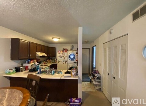 A kitchen with a table and chairs in it.