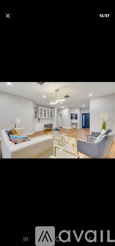A modern living room with a white sofa and a coffee table.