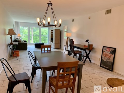 A dining room with a wooden table and chairs.