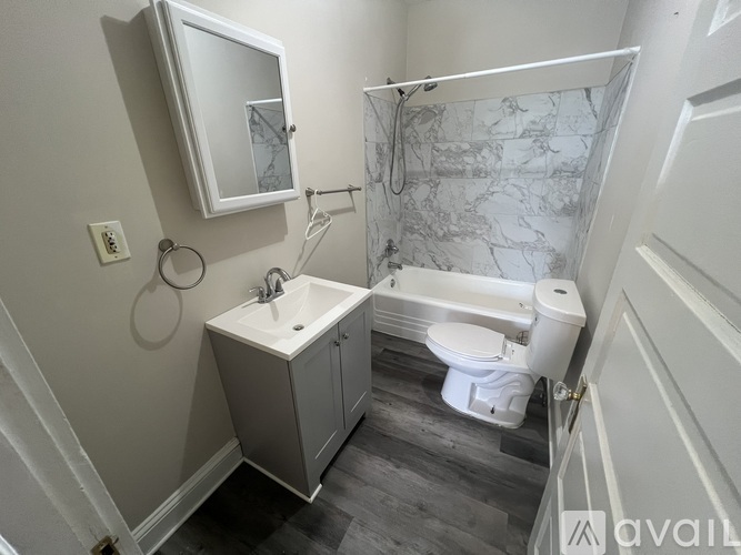 A bathroom with a white sink and toilet.