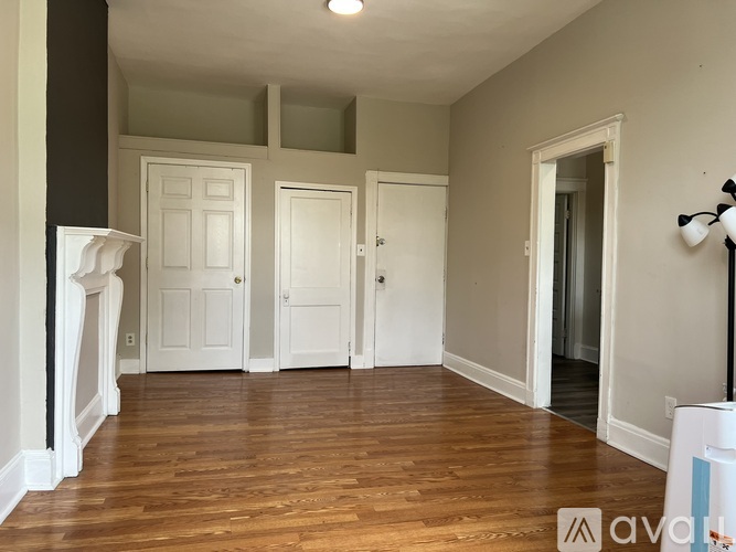 A room with wooden floors and white doors.