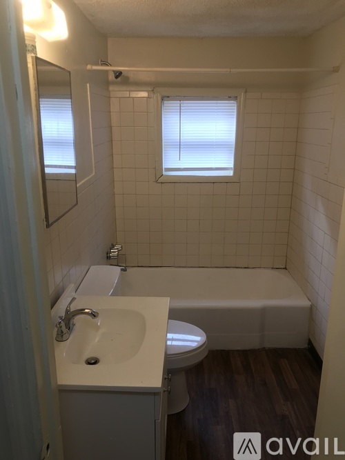 A bathroom with a white sink, toilet and bathtub.