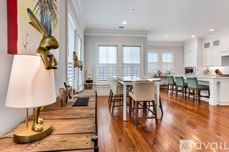 A dining room with a white table and chairs.