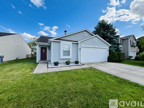A house with a red door and a garage is for sale.