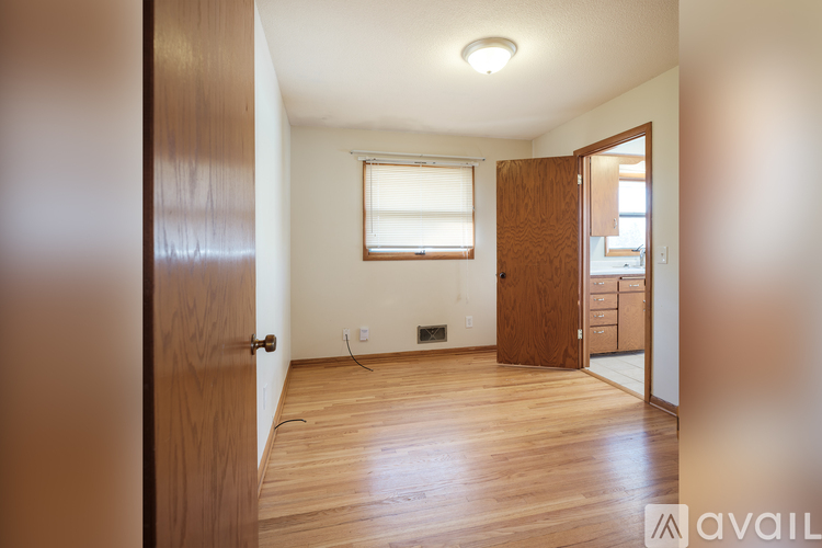 A room with wooden floors and a window.