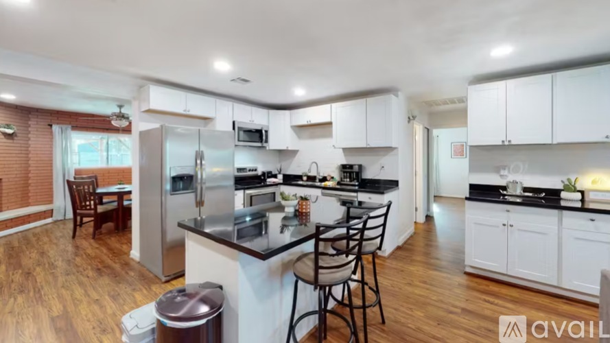 A modern kitchen with white cabinets and a center island.