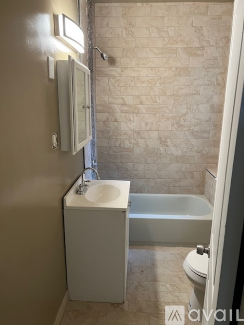 A bathroom with a sink, toilet, and bathtub.