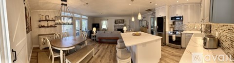 A kitchen with a table and chairs in the middle of the room.