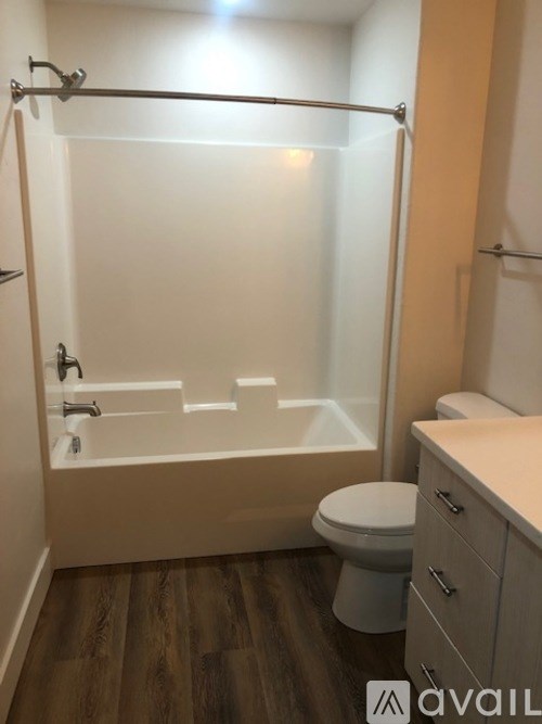 A bathroom with a toilet, a bathtub, and a sink.