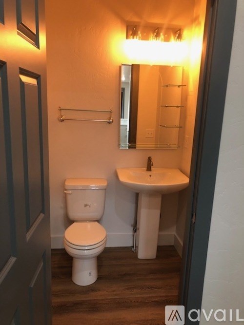 A white toilet and sink in a small bathroom.