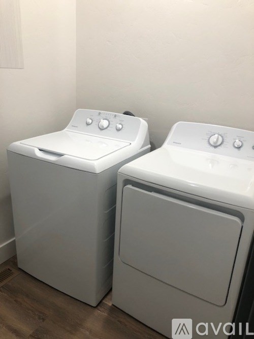 Two front loading washing machines in a laundry room.