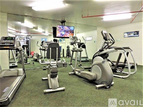 A gym with treadmills, elliptical machines, and other exercise equipment.