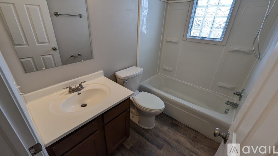 A bathroom with a sink, toilet, and bathtub.