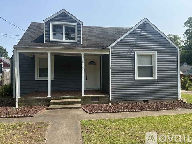 A small house with a porch and a front door.
