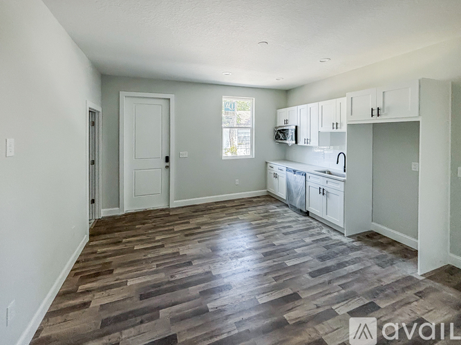 A kitchen area with a dining table and chairs.
