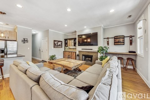A modern living room with a grey sofa and a wooden coffee table.