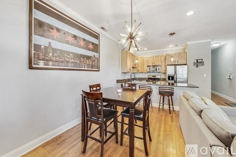A dining room with a wooden table and chairs.