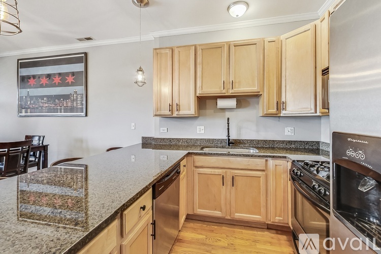 A kitchen with wooden cabinets and granite countertops.