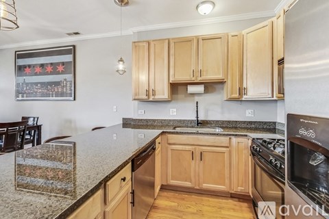 A kitchen with wooden cabinets and granite countertops.