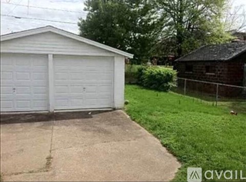 A two-car garage is situated in a grassy area.
