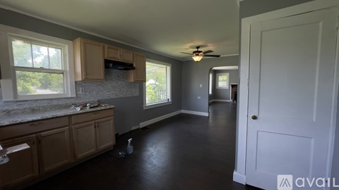 A kitchen with wooden cabinets and a marble countertop.
