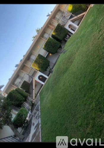 A building with a green lawn in front of it.
