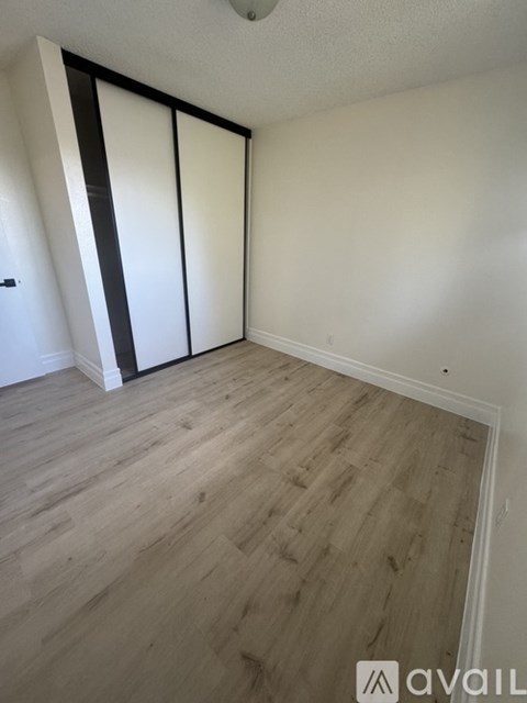 A room with a sliding door and wooden flooring.