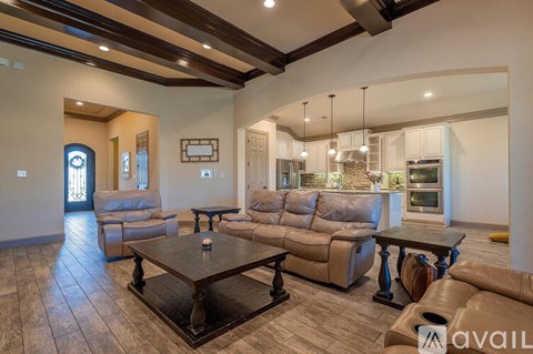 A living room with a brown leather couch and a wooden coffee table.
