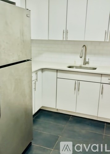 A kitchen with a sink and cabinets.