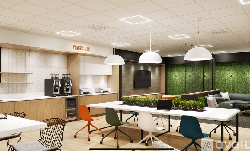 A modern office space with a green wall and a white table with chairs.