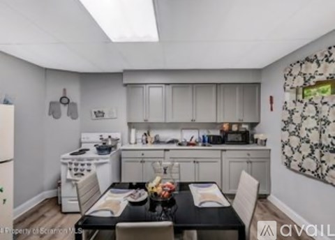 A kitchen with a dining table set for two.