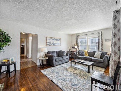 A living room with a grey couch and a coffee table.