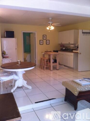 A kitchen with a table and chairs in the middle of the room.