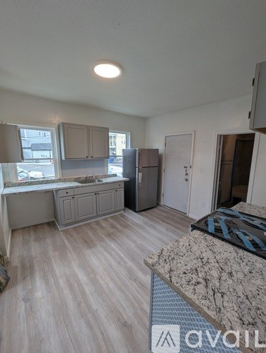 A kitchen area with a counter and a fridge.