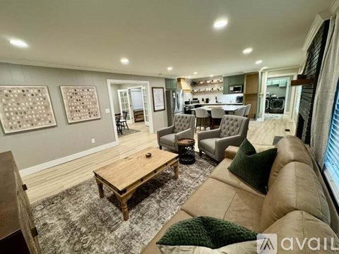 A living room with a brown couch and a wooden coffee table.