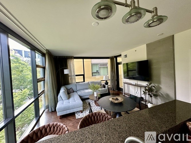 A living room with a couch, a coffee table, and a television.