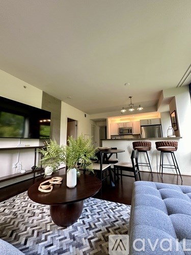 A living room with a blue couch and a coffee table.