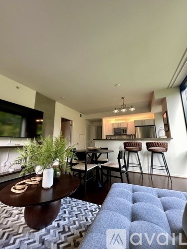 A living room with a blue couch and a wooden coffee table.